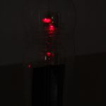 Pop-bottle magnetometer in darkness with red laser reflections